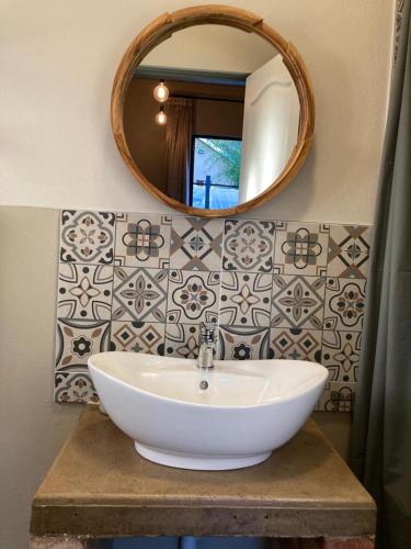 a bathroom with a white sink and a mirror at River View in Potchefstroom
