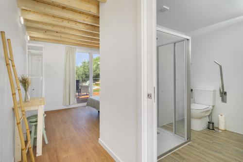 a room with a toilet and a glass door at Chaparral Wonderful house in Nature 1h from Lisbon by Soulplaces in Silveiras