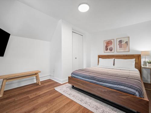 a white bedroom with a bed and a table at Shadyside, Pittsburgh, Modern and Stylish 1 Bedroom Unit5 with Free Parking in Pittsburgh