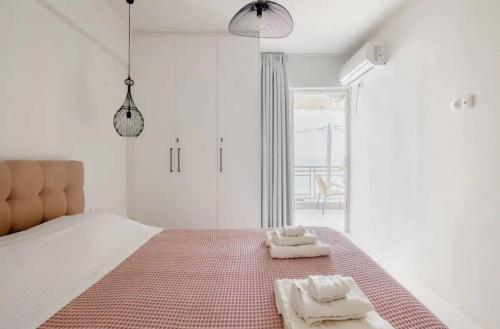 a bedroom with a bed with two towels on it at Seascape Serenade in Oropós
