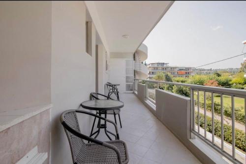 a balcony with chairs and a table on a building at Seascape Serenade in Oropós