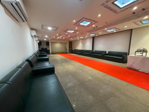 a conference room with black chairs and a red carpet at Abhi Residency Hotel in New Delhi