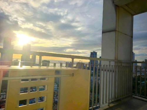 a view of the sunset from the balcony of a building at Big & Modern Condo with a Wide Balcony & Free Netflix in Manila