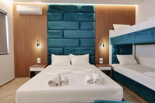 a bedroom with two beds with towels on them at Vila Shpetimi in Ksamil