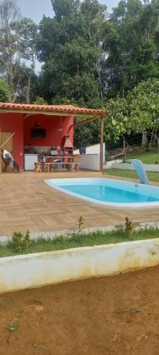 a swimming pool in front of a house at Casa para alugar ano novo in Itacaré
