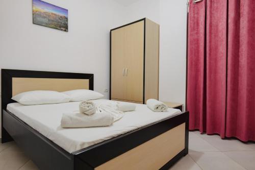 a bedroom with a bed with towels on it at Vila Shpetimi in Ksamil