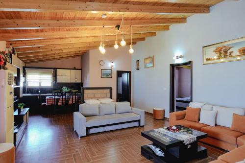 a living room with a couch and a table at Vila Shpetimi in Ksamil