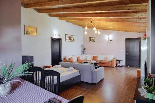 a living room with a couch and a table at Vila Shpetimi in Ksamil