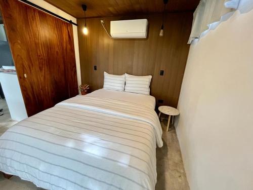 a bedroom with a large white bed in a room at Sweet Jungle Beach in Bejuco
