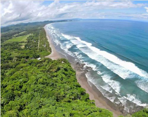 an aerial view of a beach and the ocean at Sweet Jungle Beach in Bejuco