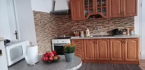 a kitchen with a counter with fruits and vegetables on it at Diana in Revúca