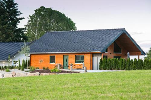 an orange house with a black roof at Chalet Hüttenzauber in Mehlmeisel