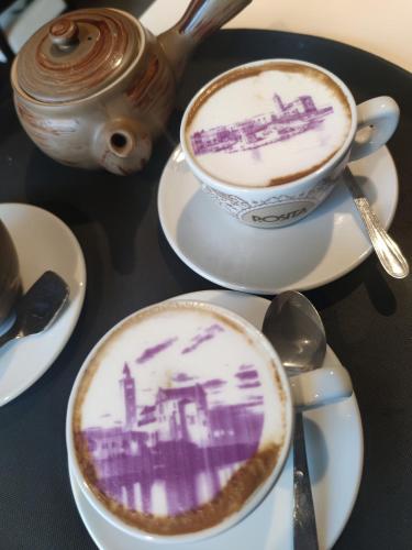 a table with two cups of coffee and a teapot at Maison Divino in Trani