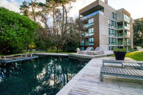 um edifício com piscina em frente a um edifício em Be House & Spa by Oceana Suites em Punta del Este