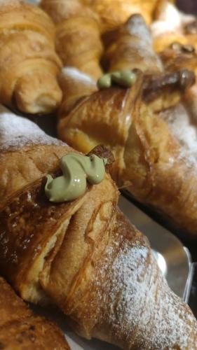 a pile of pastries sitting on top of a plate at Maison Divino in Trani