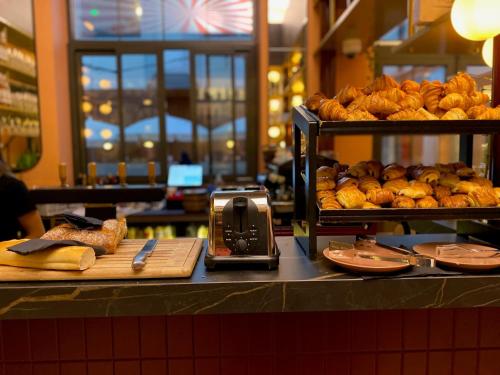 a bakery with bread and pastries on a counter at ClapClap Hôtel, Food & Bar in Strasbourg