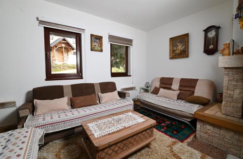 sala de estar con 2 sofás y chimenea en Apartment Tom, en Jahorina