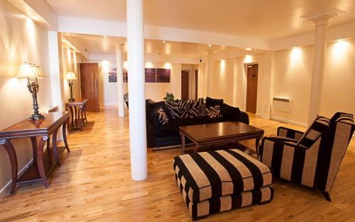 a living room with a couch and a table at Trinity Quay Apartments in Aberdeen