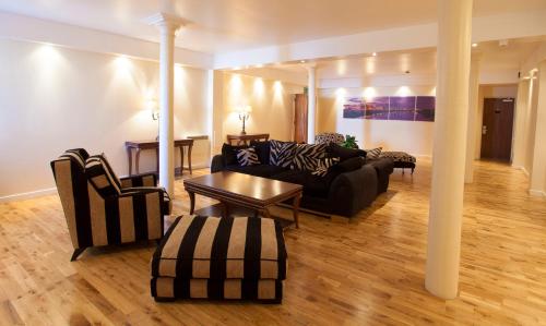 a living room with a couch and a table at Trinity Quay Apartments in Aberdeen