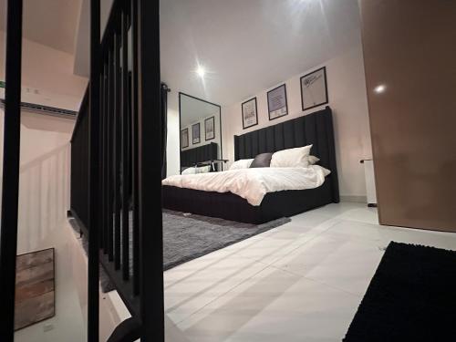 a bedroom with a bed with a black headboard at COC00N by IVY in Lagos