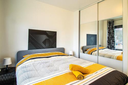 a bedroom with two beds and a large mirror at ZenBNB / La Gallery /Proche Suisse in Saint-Julien-en-Genevois