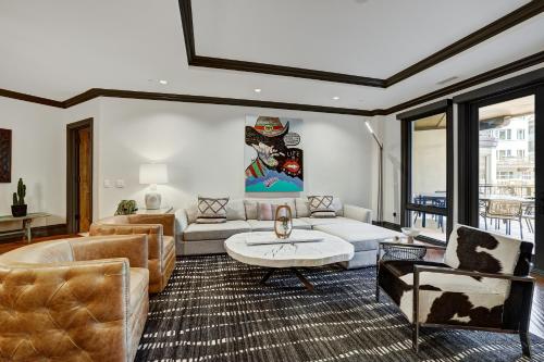 a living room with a couch and a table at Luxury 3 Bedroom Condo at The Arrabelle condo in Vail