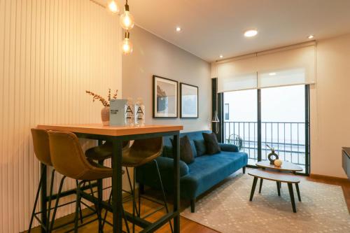 a living room with a table and a blue couch at Great 2BR with Balcony in the Heart of Miraflores in Lima