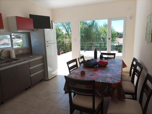 a kitchen and dining room with a table and chairs at Lo de Marga - hasta 7 personas- in Federación