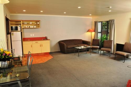 a living room with a couch and a table at Chancellor Motor Lodge and Conference Centre in Palmerston North