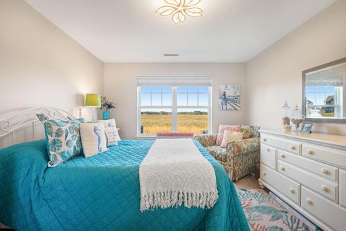 a bedroom with a bed and a dresser and a window at Bethany Bay -- 37185 Harbor #3602 in Ocean View