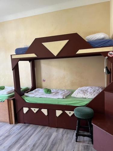 two bunk beds in a room with a desk and a chair at Homeplanet Hostel in Leipzig