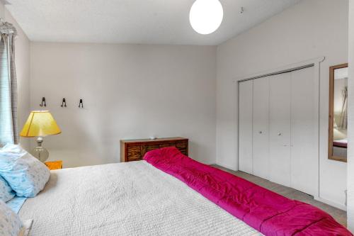 a bedroom with a large bed with a red comforter at Olympic Loop 405S in Girdwood