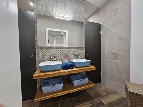 a bathroom with two sinks and a mirror at Stunning Seafront Portomaso Apartment in Paceville