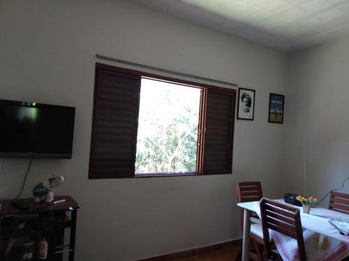 a window in a room with a table and a dining room at Rancho Belo in São José da Barra