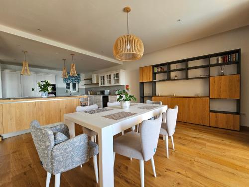 a kitchen and dining room with a table and chairs at Stunning Seafront Portomaso Apartment in Paceville