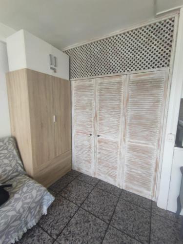 a bedroom with a bed and a closet with sliding doors at La Siesta Apt in Salou