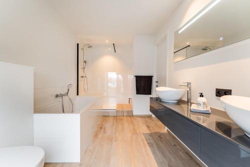 a white bathroom with a sink and a shower at Modern & Spacious House in Kortrijk