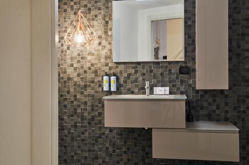 a bathroom with a sink and a mirror at Milan Retreats Brera in Milan