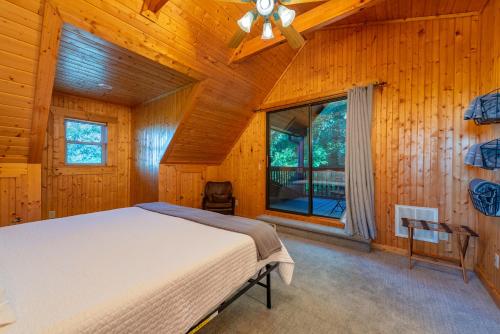 a bedroom with a bed and a large window at Summit Sunsets Pets & Year-Round Mountain Views! in Marion