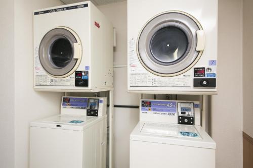 two washing machines and a washer and dryer in a room at Hotel A'bant Shizuoka in Shizuoka