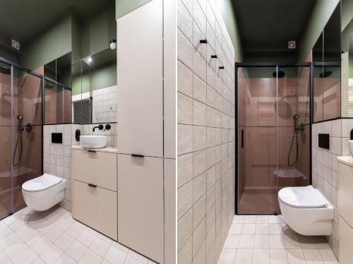 a bathroom with two toilets and a shower at Stary Browar Cosy Studio in Poznań