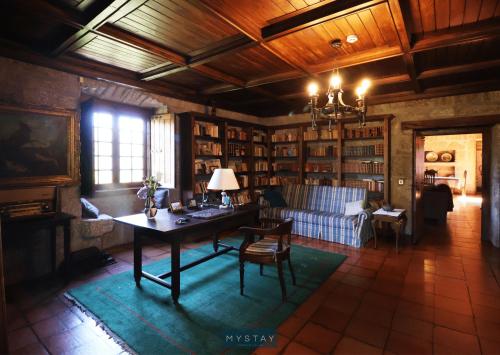 a living room with a table and a couch at MyStay - Quinta da Balança in Terras de Bouro