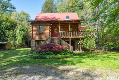 a log cabin with a red roof on a yard at Stoney Creek Cabin Creekside Cabin Close to Town in Black Mountain