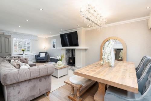 a living room with a couch and a table at 4 Bedroom, 7 Bed, 2.5 Bath - Detached House in Cheadle