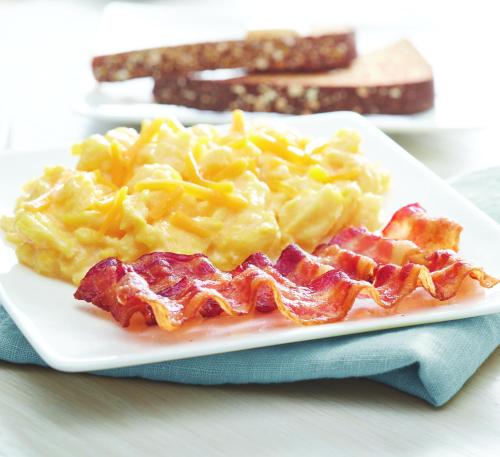 a plate of food with bacon and macaroni and cheese at Fairfield Inn & Suites by Marriott San Antonio Airport/North Star Mall in San Antonio
