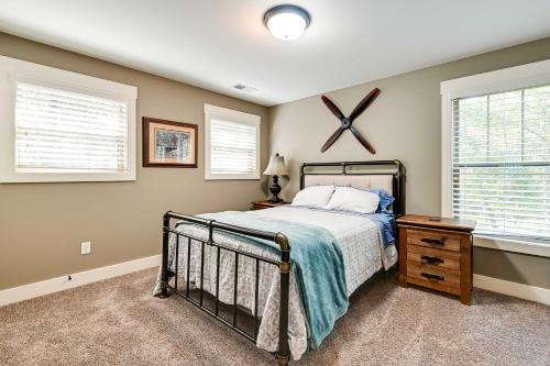 a bedroom with a bed and two windows at Nolin Lake Home with Hot Tub 15 Mi to Mammoth Cave! in Cub Run