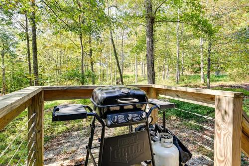 a motorcycle on a wooden bridge in the woods at Nolin Lake Home with Hot Tub 15 Mi to Mammoth Cave! in Cub Run