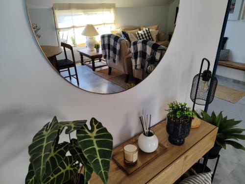 a living room with a mirror and a table with plants at Evans Realty AT Ático & Centro & Playa & Vistas mar in Fuengirola