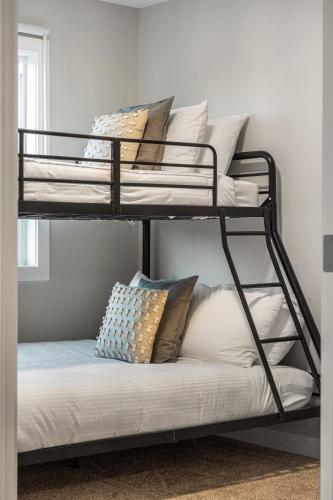 two bunk beds with pillows on a couch in a room at Serene Peaks, Private Hot Tub, Peaceful in Radium Hot Springs