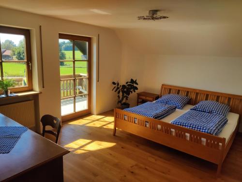 two beds in a room with two windows at Richie's Landhaus im Allgäu in Pfaffenhausen
